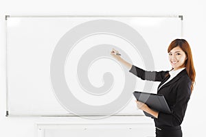 Asian smiling business woman teaching with a white board