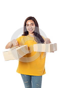 Asian smiling women holding a paper box package on a white background. Delivery concept