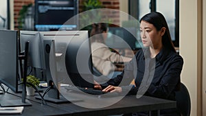 Asian software developer focused on writing code encounters unexpected compiling error sitting at desk