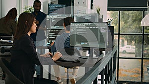 Asian software engineer working with user interface on computer screen