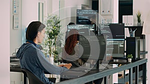 Asian software programer writing code on computer