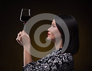 Asian sommelier woman with glass of red wine