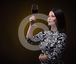 Asian sommelier woman with glass of red wine