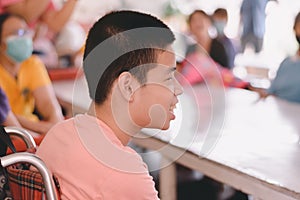 Asian special child on wheelchair in classroom for disabilities children photo