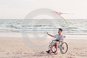 Asian special child on wheelchair playing and doing outdoor activities