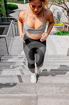 Asian sport girl doing stretching, yoga fitness and plank exercise outside. Fit young thai woman doing training workout