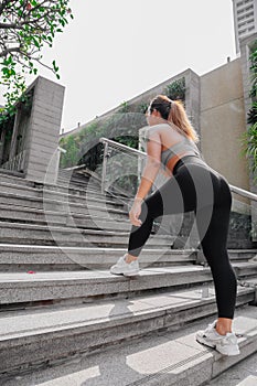 Asian sport girl doing stretching, yoga fitness and plank exercise outside. Fit young thai woman doing training workout