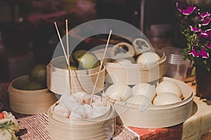 Asian steamed buns in bamboo steamers at street food market