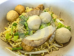 Asian Street Food. Closeup Egg noodle with varieties of fish meatballs