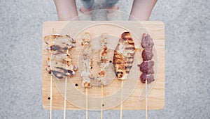 Asian Street Food. Grilled Chicken, Meat and Pork on wooden tray