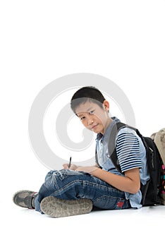 Asian student boy sitting and writing something