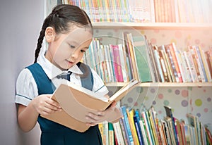 Asian student cute girl reading book in library