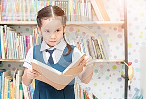 Asian student cute girl reading book in library