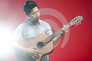 Asian Student playing guitar