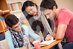 Asian student studying with classmates in classroom