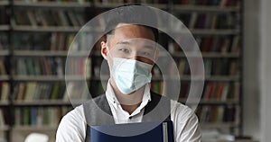 Asian student wear protective face mask posing in university library