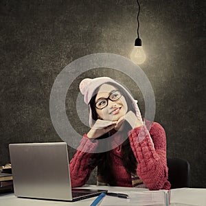 Asian student in winter clothes looking at lamp