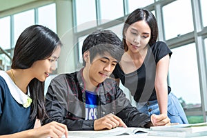 Asian student working home work togather in library in university