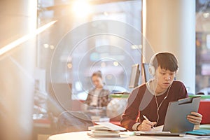 Asian student working in the library