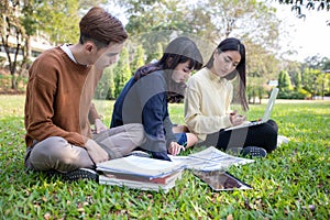 Asian students use notebook computers and tablet to work and study online in the garden at home