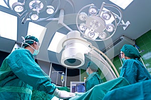 Asian surgeons team working with Monitoring of patient in surgical operating room