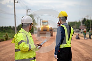 Asian surveyor engineers use tablet to check detail in job, Control schedule of work of highway road construction projects with