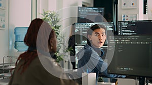 Asian system engineer asking coder for help with html code