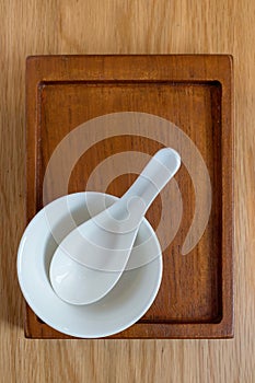 White cup and spoon on tray