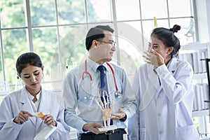 Asian teacher has teaching to student about science and anatomical in laboratory