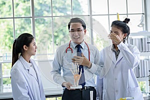 Asian teacher has teaching to student about science and anatomical in laboratory