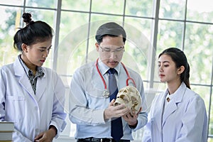 Asian teacher has teaching to student about science and anatomical in laboratory