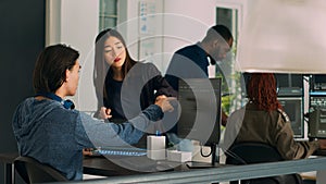 Asian team of IT engineers analyzing html code on terminal window