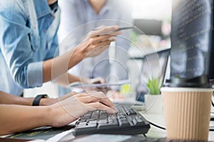 Asian team Outsource Developer Looking Screen Programming Code W