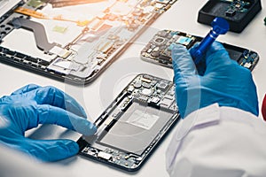 The asian technician repairing the smartphone`s motherboard in the lab with copy space. the concept of computer hardware, mobile p