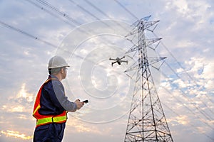 Asian technician use drone to fly inspections at the electric power station to view the planning work by producing electricity