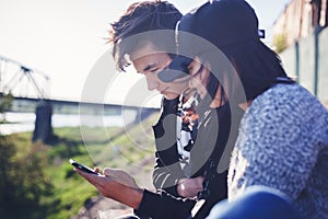 Asian teen boy and girl look in smartphone, communicate, have fun, millenial, teenagers rest together