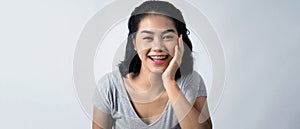 Asian teen facial with braces smiling to camera to show orthodonic teeth