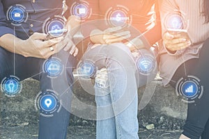 Asian teen friends sitting with smart phone in hand connect to social media with technology networking