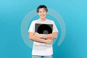 Asian Teen Guy Holding Hugging Laptop Standing Over Blue Background