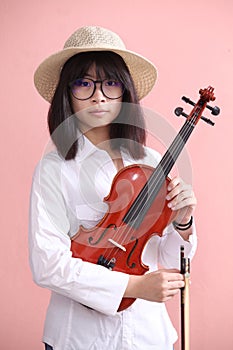 Asian teen with violin glasses hat smile