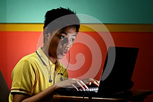 Asian Teen Working on a Laptop Computer