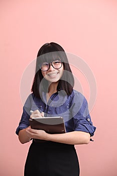 Asian teen writing tablet