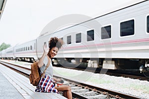 Asian teenage girl african american traveler dressed in casual wear holding map and searching right direction of route