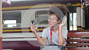 Asian teenage girl african american traveling using smartphone moblie video call with family or friends while waiting