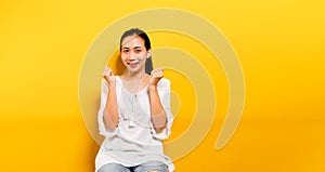Asian teenage girl feeling happy. smiling and looking at the camera in taking pictures of himself yellow studio photography Smile