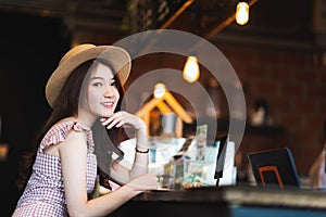 Asian teenage girl smiling in coffee shop with copy space. Cafe culture casual lifestyle, happy traveler woman concept