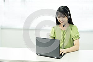 Asian teenage girl using a laptop