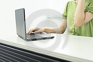 Asian teenage girl using a laptop