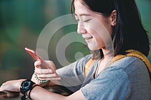 Asian teenage girl is using a smartphone