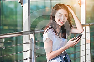 Asian teenage girl is using a smartphone